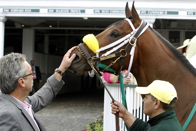 Trainer Gary Contessa pets Kentucky Derby entrant Uncle Sigh as they school in the paddock at Churchill Downs Friday, May 2, 2014, in Louisville, Ky. (AP Photo/Garry Jones)