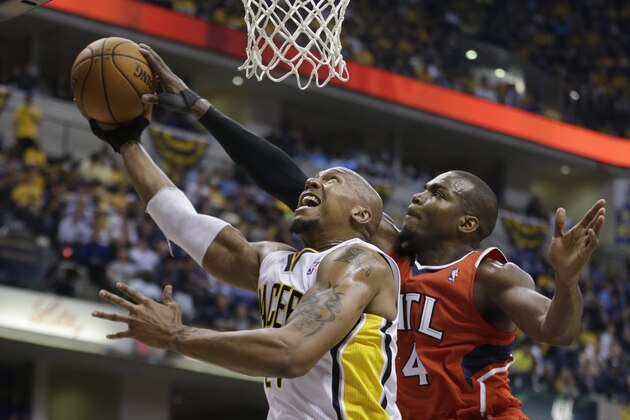 Indiana Pacers' David West (21) has his shot blocked by Atlanta Hawks' Paul Millsap (4) during the second half in Game 5 of an opening-round NBA basketball playoff series Monday, April 28, 2014, in Indianapolis. Atlanta defeated Indiana 107-97. (AP Photo/Darron Cummings)