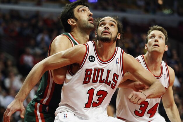 FILE - In this April 4, 2014 file photo, Chicago Bulls center Joakim Noah (13) defends against Milwaukee Bucks center Zaza Pachulia during an NBA basketball game in Chicago.  A person familiar with the situation says that Noah is the NBA's Defensive Player of the Year. The person spoke Monday, April 21, 2014 on the condition of anonymity because the award had not been announced. (AP Photo/Kamil Krzaczynski, File)