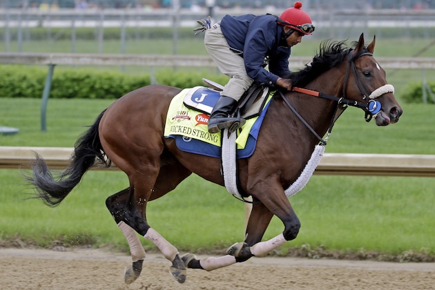 Exercise rider Kelvin Pahal takes Kentucky Derby hopeful Wicked Strong for a morning workout at Churchill Downs Wednesday, April 30, 2014, in Louisville, Ky. (AP Photo/Morry Gash)