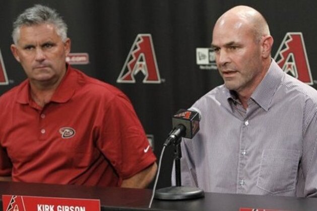 Arizona Diamondbacks manager Kirk Gibson, right, talks during a news conference as general manager Kevin Towers listens on Monday, Oct. 4, 2010, in Phoenix.  Hired as the interim manager after a midseason shake-up, Gibson was given the permanent job on Monday, signing a two-year deal with a team option for 2013. (AP Photo/Ross D. Franklin)