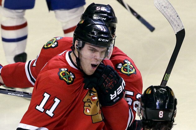 Chicago Blackhawks' Jeremy Morin (11) celebrates with Nick Leddy (8) and Brandon Bollig (52) after scoring his goal during the third period of an NHL hockey game against the Montreal Canadiens in Chicago, Wednesday, April 9, 2014. The Blackhawks won 3-2 in overtime. (AP Photo/Nam Y. Huh)