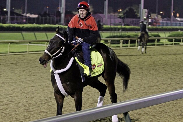 Exercise rider Bryan Beccia takes Kentucky Derby entrant Ride On Curlin for a morning workout at Churchill Downs Saturday, May 3, 2014, in Louisville, Ky. (AP Photo/Garry Jones)
