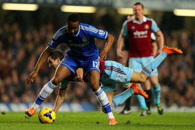 LONDON, ENGLAND - JANUARY 29:  Stewart Downing of West Ham clashes with John Obi Mikel of Chelsea during the Barclays Premier League match between Chelsea and West Ham United at Stamford Bridge on January 29, 2014 in London, England.  (Photo by Ian Walton/Getty Images)