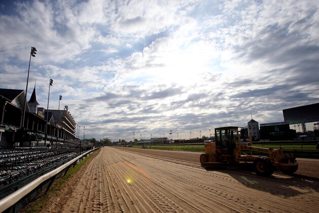 May 3, 2014; Louisville, KY, USA; Tractors rake the track before the 2014 Kentucky Derby at Churchill Downs. Mandatory Credit: Jerry Lai-USA TODAY Sports