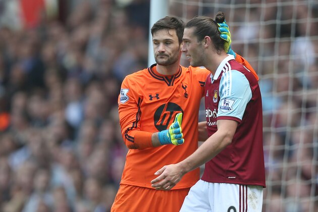 West Ham's Andy Carroll, right, is hugged after a collision by Tottenham's goalkeeper Hugo Lloris during their English Premier League soccer match between West Ham United and Tottenham Hotspur at the Boleyn stadium in London Saturday, May  3  2014. (AP Photo/Alastair Grant)