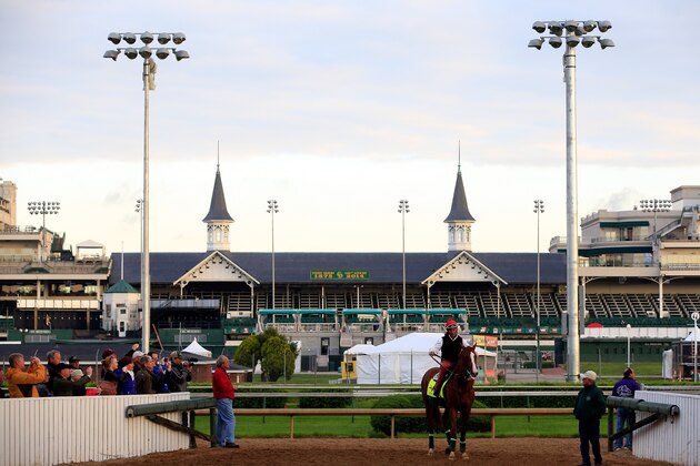 LOUISVILLE, KY - MAY 01:  California Chrome walks off the track with trainer Art Sherman in front of the twin spires during early morning workouts at Churchill Downs on May 1, 2014 in Louisville, Kentucky.  (Photo by Jamie Squire/Getty Images)