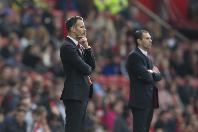 As he stands on the touchline alongside rival manager Gus Poyet, Manchester United's interim manager Ryan Giggs, left, ponders the situation as his team lose 1-0 to Sunderland  during their English Premier League soccer match at Old Trafford Stadium, Manchester, England, Saturday May 3, 2014. (AP Photo/Jon Super)
