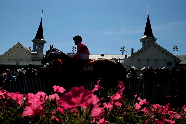 LOUISVILLE, KY - MAY 03:  A horse and jockey walk past the twin spires prior to the 140th running of the Kentucky Derby at Churchill Downs on May 3, 2014 in Louisville, Kentucky.  (Photo by Kevin C. Cox/Getty Images)