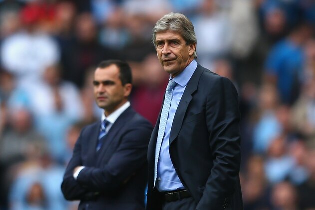 MANCHESTER, ENGLAND - OCTOBER 05:  Manuel Pellegrini (R) the manager of Manchester City alongside Roberto Martinez (L) the manager of Evertonon during the Barclays Premier League match between Manchester City and Everton at the Etihad Stadium on October 5, 2013 in Manchester, England.  (Photo by Michael Steele/Getty Images)