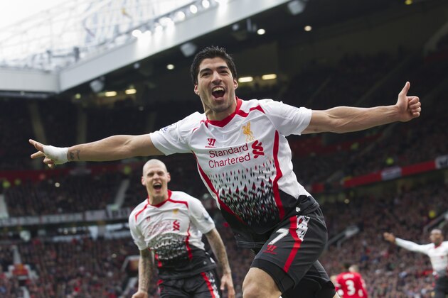 Liverpool's Luis Suarez celebrates after scoring against Manchester United, during their English Premier League soccer match at Old Trafford Stadium, Manchester, England, Sunday, March 16, 2014. (AP Photo/Jon Super)