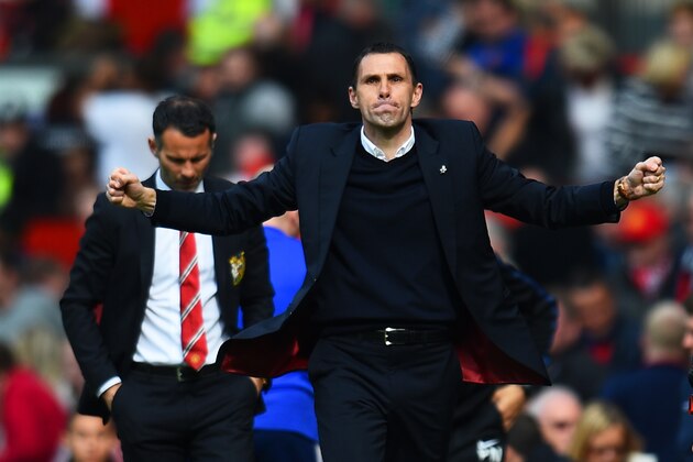 MANCHESTER, ENGLAND - MAY 03:  Gustavo Poyet the Sunderland manager celebrates his team's 1-0 victory as a dejected Ryan Giggs the Manchester United interim manager walks behind during the Barclays Premier League match between Manchester United and Sunderland at Old Trafford on May 3, 2014 in Manchester, England.  (Photo by Shaun Botterill/Getty Images)