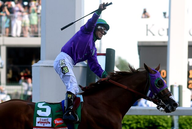 LOUISVILLE, KY - MAY 03:  Jockey Victor Espinoza celebrates atop of California Chrome #5 after crossing the finish line to win the 140th running of the Kentucky Derby at Churchill Downs on May 3, 2014 in Louisville, Kentucky.  (Photo by Dylan Buell/Getty Images)