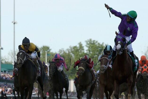 LOUISVILLE, KY - MAY 03:  Jockey Victor Espinoza celebrates atop of California Chrome #5 after crossing the finish line to win the 140th running of the Kentucky Derby at Churchill Downs on May 3, 2014 in Louisville, Kentucky.  (Photo by Matthew Stockman/Getty Images)