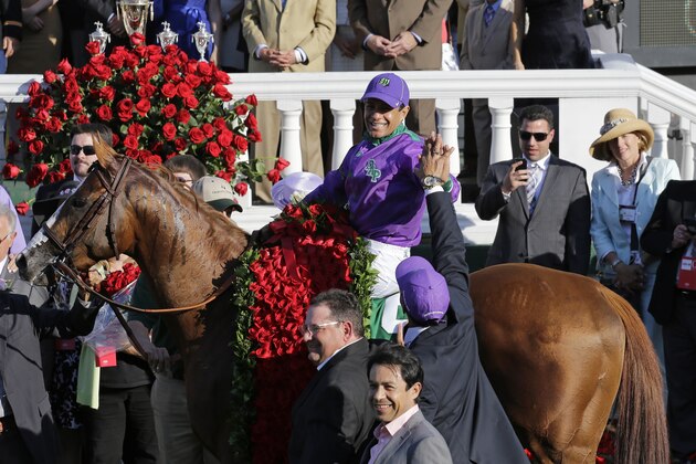 Victor Espinoza celebrates after riding California Chrome to a victory during the 140th running of the Kentucky Derby horse race at Churchill Downs Saturday, May 3, 2014, in Louisville, Ky. (AP Photo/David J. Phillip)