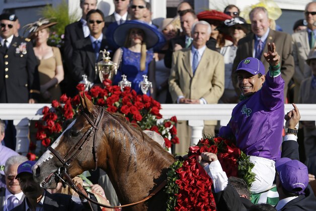 Victor Espinoza celebrates after riding California Chrome to victory in the 140th running of the Kentucky Derby horse race at Churchill Downs Saturday, May 3, 2014, in Louisville, Ky. (AP Photo/David Goldman)