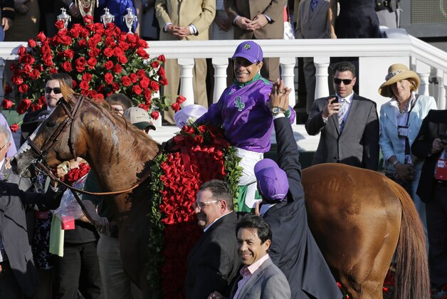 Victor Espinoza celebrates after riding California Chrome to a victory during the 140th running of the Kentucky Derby horse race at Churchill Downs Saturday, May 3, 2014, in Louisville, Ky. (AP Photo/David J. Phillip)