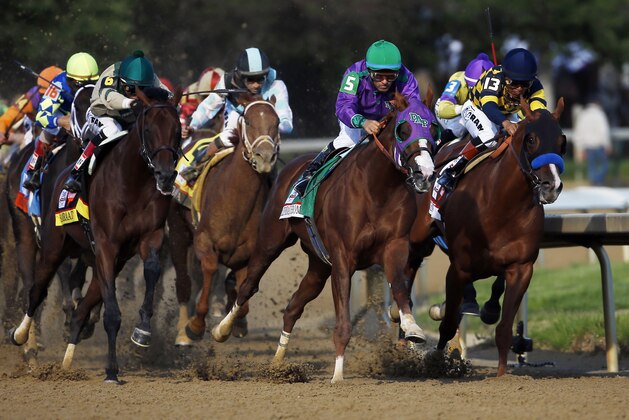 Victor Espinoza rides California Chrome around turn four to a victory during the 140th running of the Kentucky Derby horse race at Churchill Downs Saturday, May 3, 2014, in Louisville, Ky. (AP Photo/Matt Slocum)