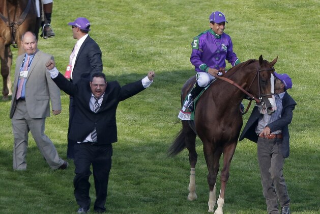Assistant trainer Alan Sherman, left, after Victor Espinoza rode   California Chrome to victory in the 140th running of the Kentucky Derby horse race at Churchill Downs Saturday, May 3, 2014, in Louisville, Ky. (AP Photo/Charlie Riedel)