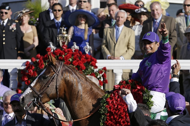 Victor Espinoza celebrates after riding California Chrome to victory in the 140th running of the Kentucky Derby horse race at Churchill Downs Saturday, May 3, 2014, in Louisville, Ky. (AP Photo/David Goldman)