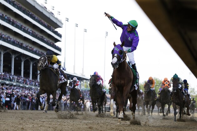 Victor Espinoza rides California Chrome to victory during the 140th running of the Kentucky Derby horse race at Churchill Downs Saturday, May 3, 2014, in Louisville, Ky.  (AP Photo/David J. Phillip)