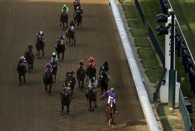 Victor Espinoza rides California Chrome to a victory during the 140th running of the Kentucky Derby horse race at Churchill Downs Saturday, May 3, 2014, in Louisville, Ky. (AP Photo/Charlie Riedel)