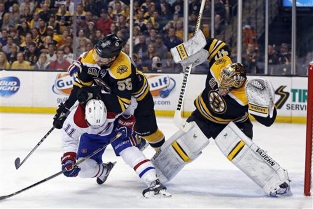 Boston Bruins defenseman Johnny Boychuk (55) checks Montreal Canadiens right wing Brendan Gallagher (11) as Bruins goalie Tuukka Rask (40) protects the net during the first period in Game 2 of an NHL hockey second-round playoff series in Boston, Saturday, May 3, 2014. (AP Photo/Elise Amendola)