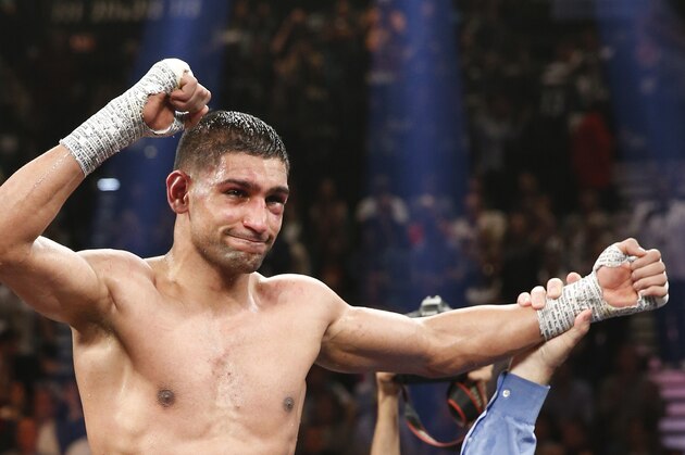 England's Amir Khan celebrates his unanimous decision over Luis Collazo in their silver welterweight title boxing fight Saturday, May 3, 2014, in Las Vegas. (AP Photo/Eric Jamison)
