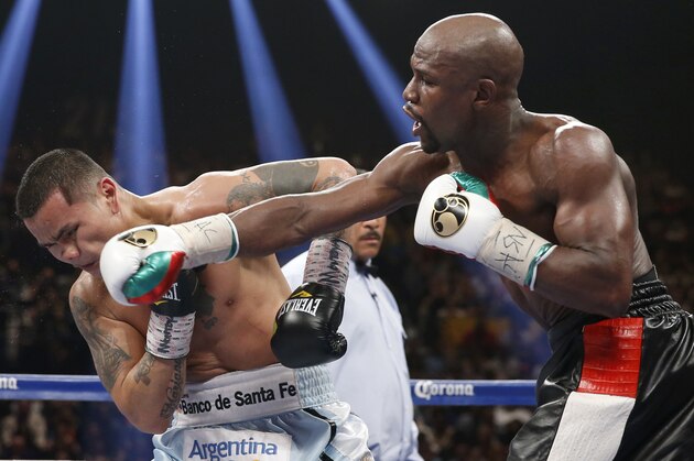 Floyd Mayweather Jr., right, connects with a right to the head of Marcos Maidana, from Argentina, in their WBC-WBA welterweight title boxing fight Saturday, May 3, 2014, in Las Vegas. (AP Photo/Eric Jamison)