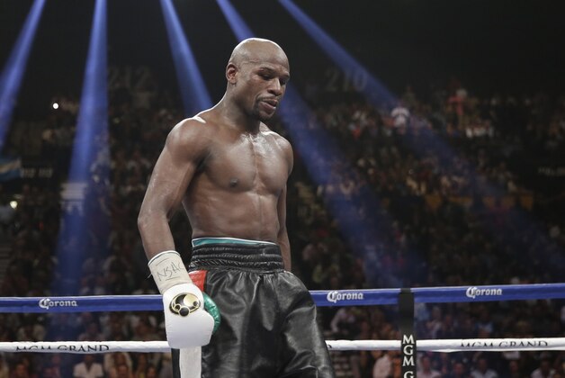 Floyd Mayweather Jr. stands in the ring during his WBC-WBA welterweight title boxing fight against Marcos Maidana Saturday, May 3, 2014, in Las Vegas. (AP Photo/Isaac Brekken)
