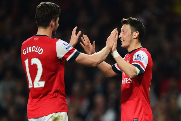 LONDON, ENGLAND - APRIL 28:  Mesut Oezil of Arsenal (11) celebrates with Olivier Giroud as he scores their second goal during the Barclays Premier League match between Arsenal and Newcastle United at Emirates Stadium on April 28, 2014 in London, England.  (Photo by Jamie McDonald/Getty Images)