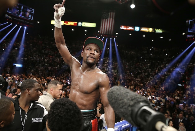 Floyd Mayweather Jr. celebrates his WBC-WBA welterweight title boxing fight victory over Marcos Maidana Saturday, May 3, 2014, in Las Vegas. (AP Photo/Eric Jamison)