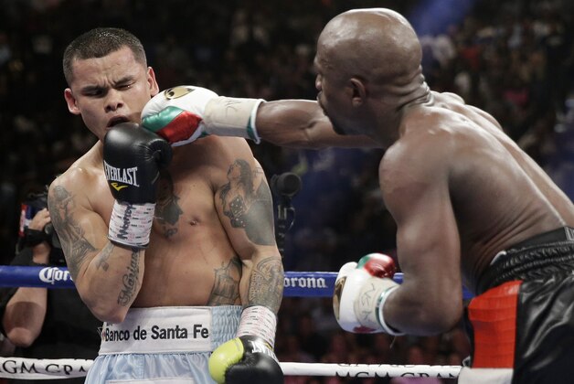 Floyd Mayweather Jr., right, connects with a right to the head of Marcos Maidana, from Argentina, in their WBC-WBA welterweight title boxing fight Saturday, May 3, 2014, in Las Vegas. (AP Photo/Isaac Brekken)
