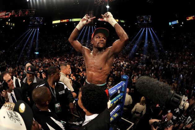 LAS VEGAS, NV - MAY 03:  Floyd Mayweather Jr. celebrates after defeating Marcos Maidana by majority decision in their WBC/WBA welterweight unification fight at the MGM Grand Garden Arena on May 3, 2014 in Las Vegas, Nevada. Mayweather took Maidana's title by majority decision.  (Photo by Harry How/Getty Images)