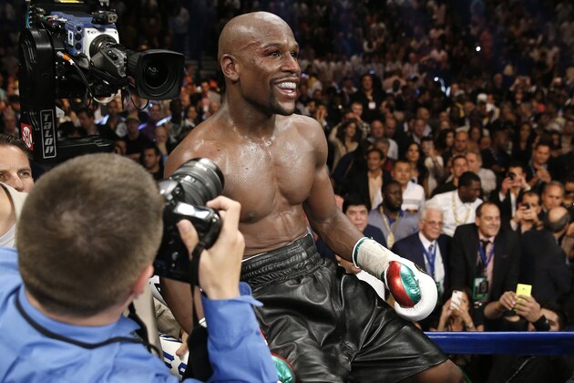 Floyd Mayweather Jr. celebrates his WBC-WBA welterweight title boxing fight victory over Marcos Maidana Saturday, May 3, 2014, in Las Vegas. (AP Photo/Eric Jamison)