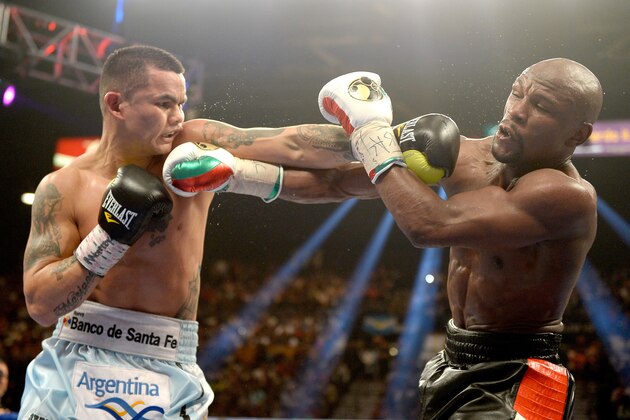 LAS VEGAS, NV - MAY 03:  (L-R) Marcos Maidana and  Floyd Mayweather Jr. exchange blows during their WBC/WBA welterweight unification fight at the MGM Grand Garden Arena on May 3, 2014 in Las Vegas, Nevada. Mayweather took Maidana's title with a majority-decision victory.  (Photo by Harry How/Getty Images)