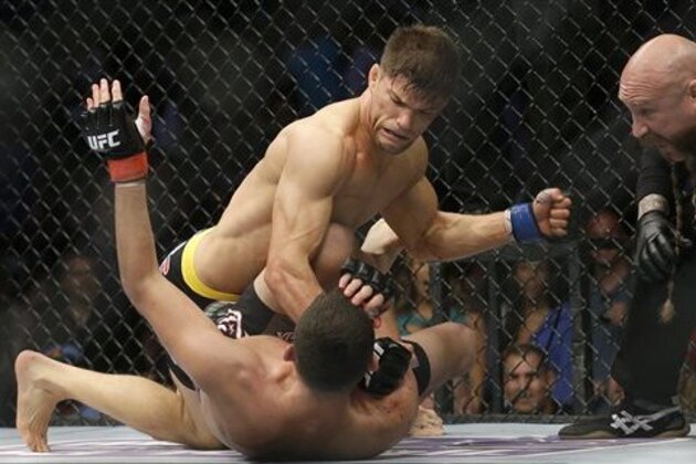 FILE - In this April 20, 2013, file photo, Josh Thomson, top, punches Nate Diaz during the second round of a UFC lightweight mixed martial arts fight in San Jose, Calif. A new study says about a third of professional mixed martial arts matches end in knockout or technical knockout, indicating a higher incidence of brain trauma than boxing or other martial arts. (AP Photo/Jeff Chiu, File)