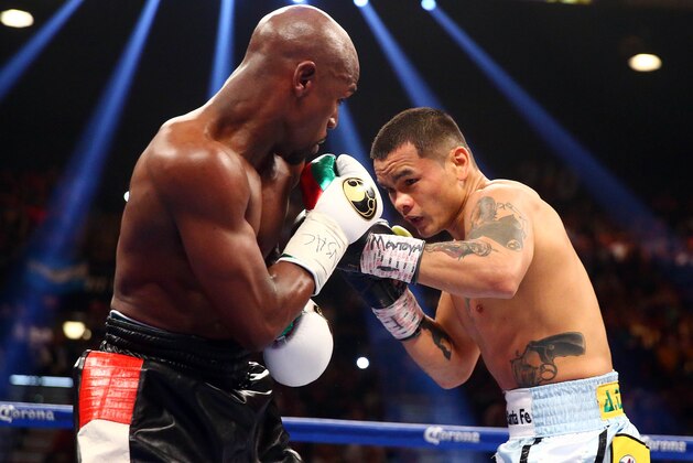 May 3, 2014; Las Vegas, NV, USA; Marcos Maidana defends against Floyd Mayweather Jr. during their fight at MGM Grand. Mandatory Credit: Mark J. Rebilas-USA TODAY Sports