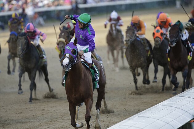 Victor Espinoza celebrates as he rides California Chrome to victory during the 140th running of the Kentucky Derby horse race at Churchill Downs Saturday, May 3, 2014, in Louisville, Ky. (AP Photo/David J. Phillip)