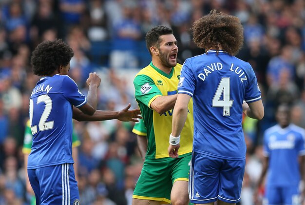 Chelsea's David Luiz, right, walks toward Norwich City's Bradley Johnson following a foul during their English Premier League soccer match at Stamford Bridge stadium in London, Sunday May 4, 2014. (AP Photo/Alastair Grant)