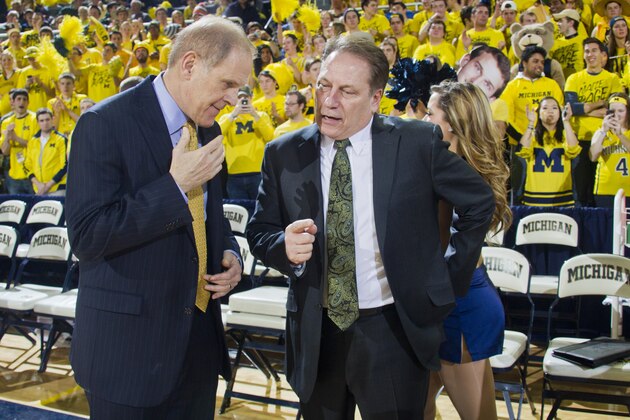Michigan head coach John Beilein, left, talks with Michigan State head coach Tom Izzo, right, before the first half of an NCAA college basketball game at Crisler Center in Ann Arbor, Mich., Sunday, Feb. 23, 2014. (AP Photo/Tony Ding)