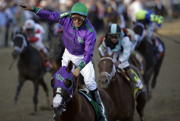 Victor Espinoza rides California Chrome to a victory during the 140th running of the Kentucky Derby horse race at Churchill Downs Saturday, May 3, 2014, in Louisville, Ky. (AP Photo/David J. Phillip)