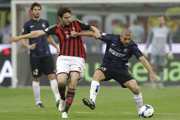 AC Milan Brazilian forward Kaka, left, challenge for the ball with Inter Milan Argentine defender Walter Samuel during a Serie A soccer match between AC Milan and Inter Milan, at the San Siro stadium in Milan, Italy, Sunday, May 4, 2014. (AP Photo/Luca Bruno)