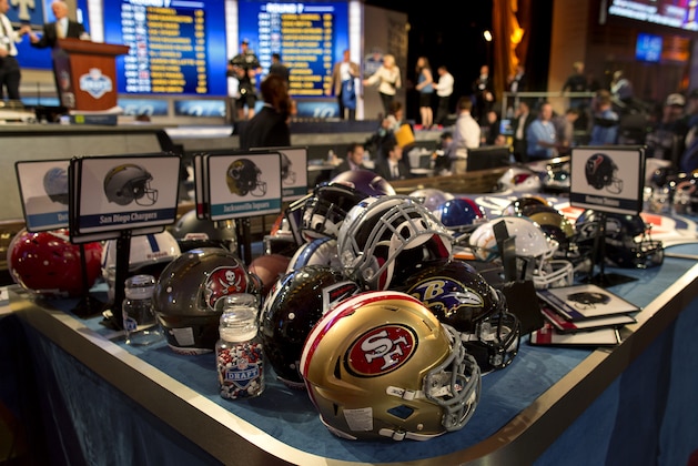 NFL helmets are stacked on a table at the conclusion of the NFL Draft, Saturday, April 27, 2013 at Radio City Music Hall in New York. (AP Photo/Craig Ruttle)