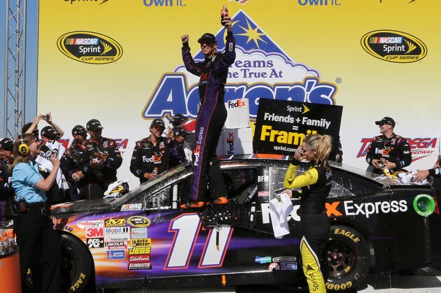 TALLADEGA, AL - MAY 04:  Denny Hamlin, driver of the #11 FedEx Express Toyota, celebrates in Victory Lane after winning the NASCAR Sprint Cup Series Aaron's 499 at Talladega Superspeedway on May 4, 2014 in Talladega, Alabama.  (Photo by Jerry Markland/Getty Images)