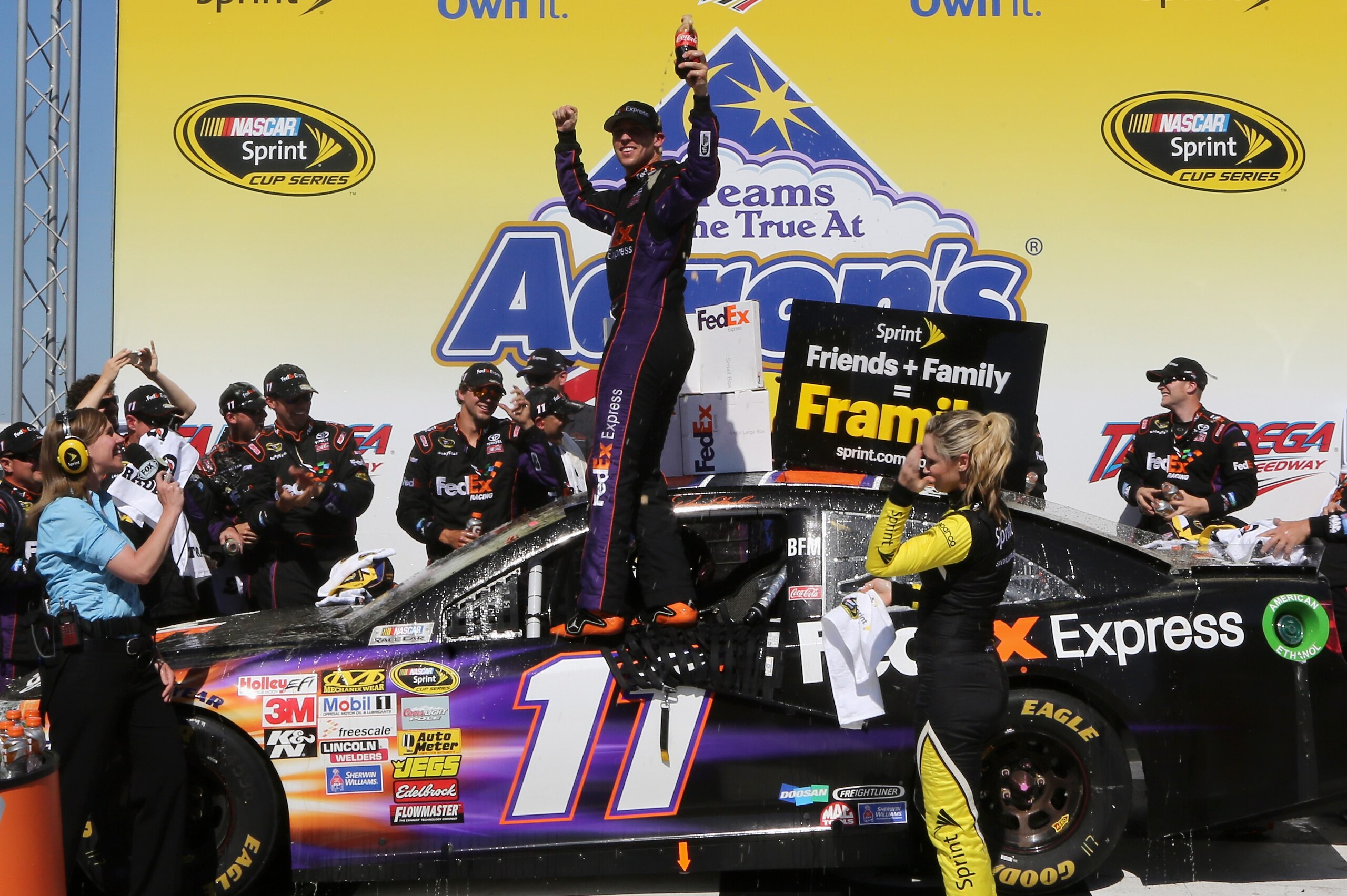 TALLADEGA, AL - MAY 04:  Denny Hamlin, driver of the #11 FedEx Express Toyota, celebrates in Victory Lane after winning the NASCAR Sprint Cup Series Aaron's 499 at Talladega Superspeedway on May 4, 2014 in Talladega, Alabama.  (Photo by Jerry Markland/Getty Images)