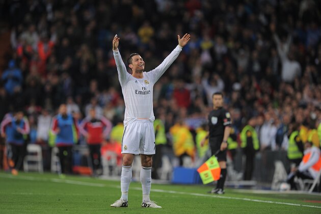 MADRID, SPAIN - APRIL 26:  Cristiano Ronaldo of Real Madrid CF celebrates after scoring Real's 2nd goal from a free kick during the La Liga match between Real Madrid CF and CA Osasuna at the Santiago Bernabeu stadium on April 26, 2014 in Madrid, Spain.  (Photo by Denis Doyle/Getty Images)