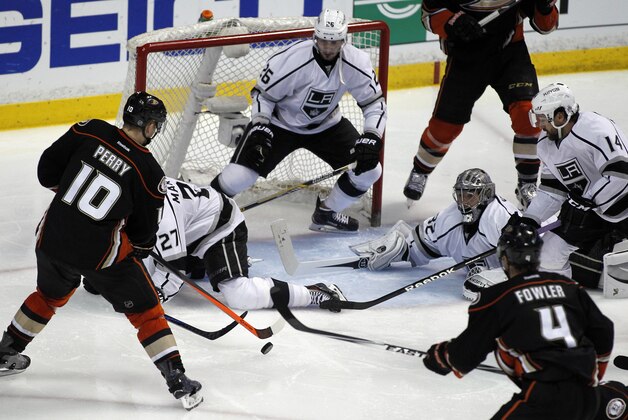 Los Angeles Kings defenseman Slava Voynov (26), of Russia, stands in the goal mouth as defenseman Alec Martinez (27), goalie Jonathan Quick (32) and right wing Justin Williams (14) defend a shot by Anaheim Ducks right wing Corey Perry during overtime in Game 1 of an NHL hockey second-round Stanley Cup playoff series in Anaheim, Calif., Saturday, May 3, 2014. Kings won 3-2 in the overtime. (AP Photo/Alex Gallardo)