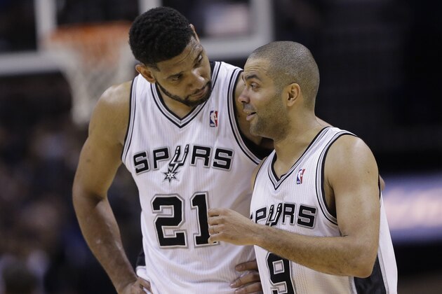 San Antonio Spurs' Tim Duncan (21) and Tony Parker (9) walk of the court during the second half of Game 7 of the opening-round NBA basketball playoff series against the Dallas Mavericks, Sunday, May 4, 2014, in San Antonio. San Antonio won 119-96. (AP Photo/Eric Gay)