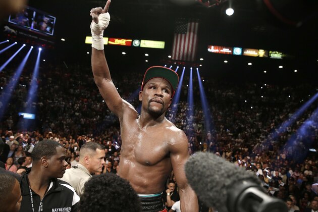 Floyd Mayweather Jr. celebrates his WBC-WBA welterweight title boxing fight victory over Marcos Maidana Saturday, May 3, 2014, in Las Vegas. (AP Photo/Eric Jamison)